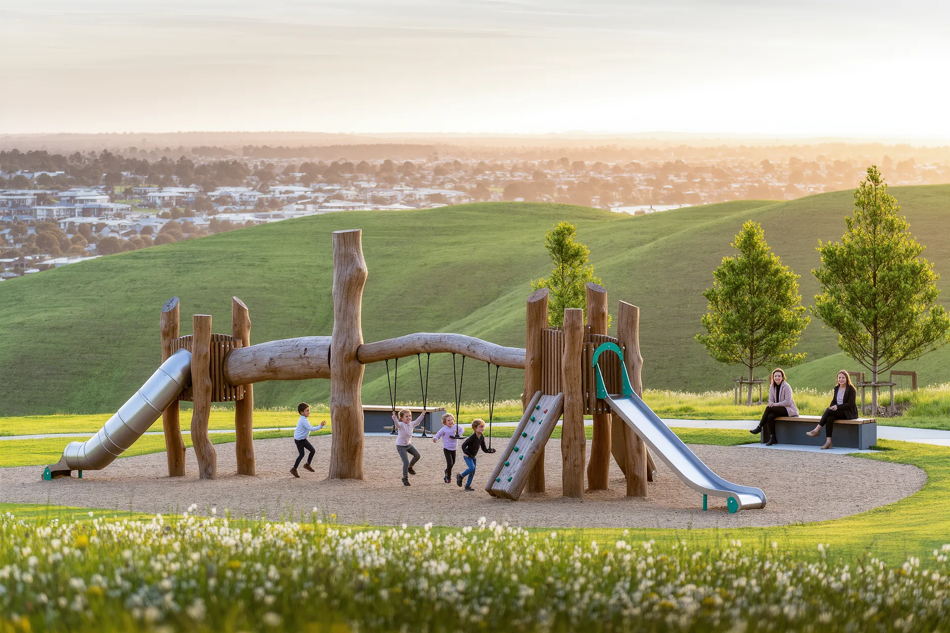 A neighbourhood playground surrounded by families.